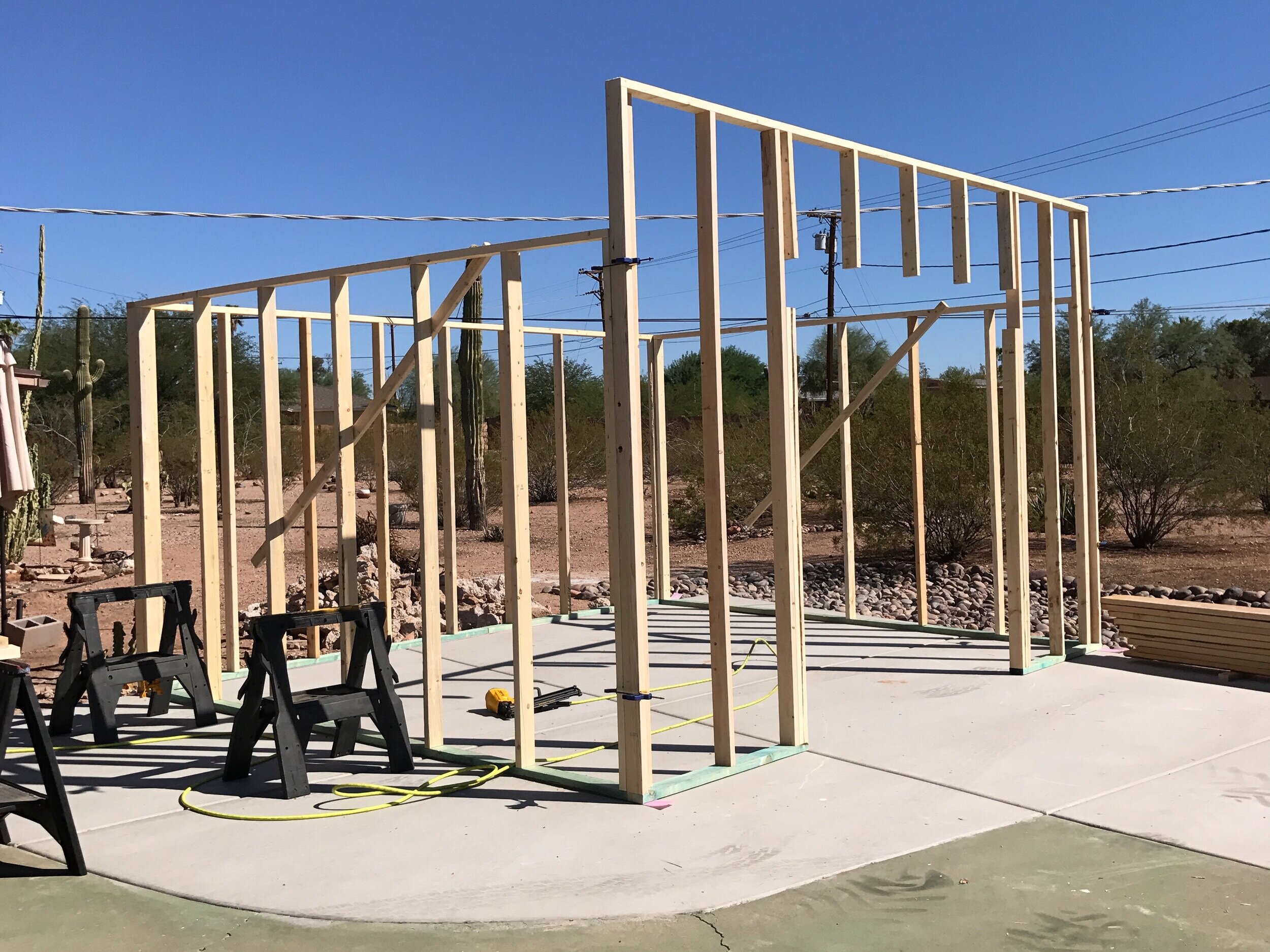 All four walls up, braced, and also squared up and plumb